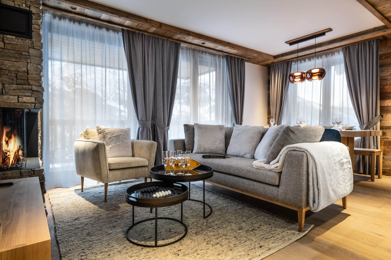Steamboat Courchevel - living area with large sofa and fireplace