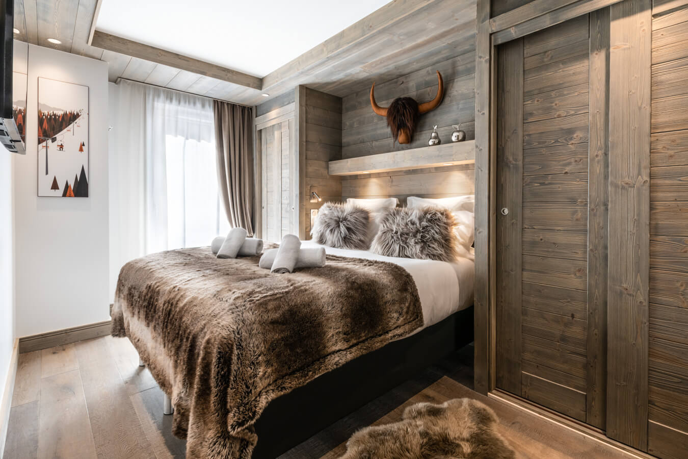 Steamboat Courchevel - double bedroom with fluffy cushions and luxurious throw