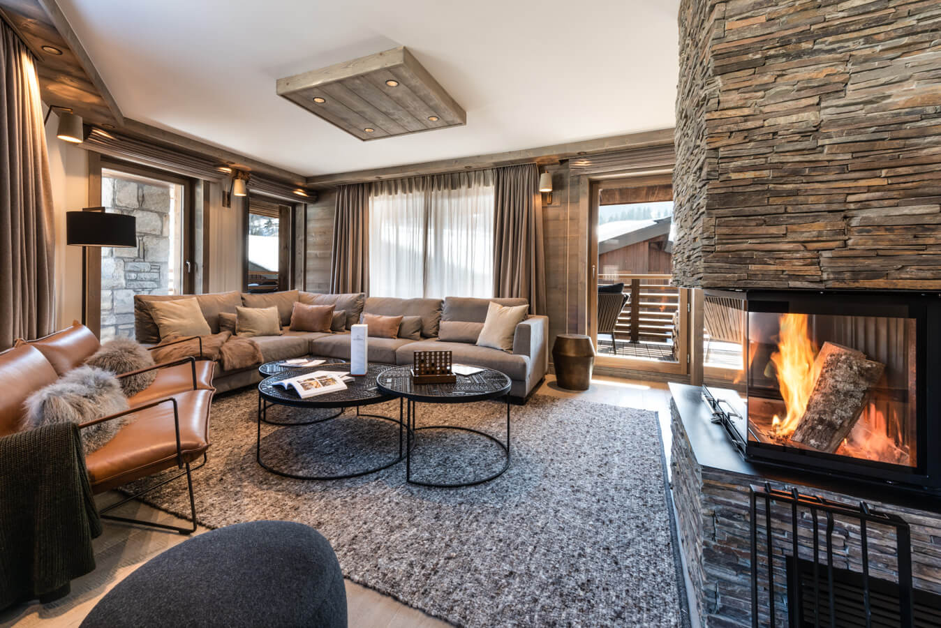 Sundance Courchevel - spacious living area with comfortable sofas and warming fire