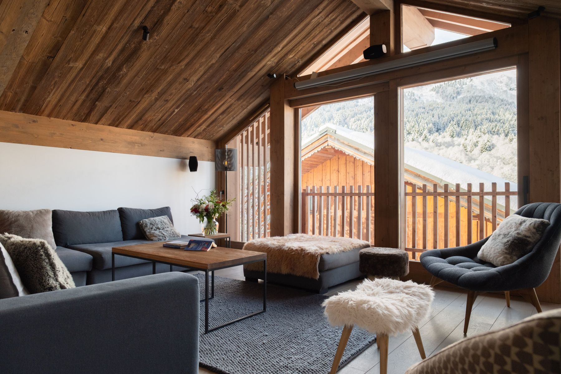 Chalet Caro, Meribel - lounge area with floor to ceiling windows and large sofas