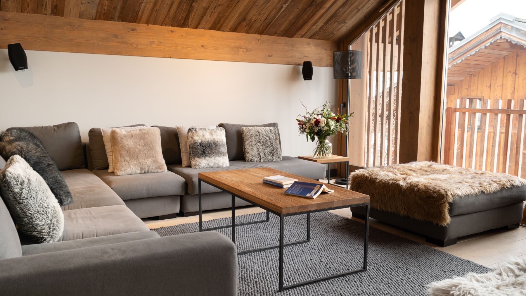 Chalet Caro, Meribel - lounge with floor to ceiling windows and large corner sofa