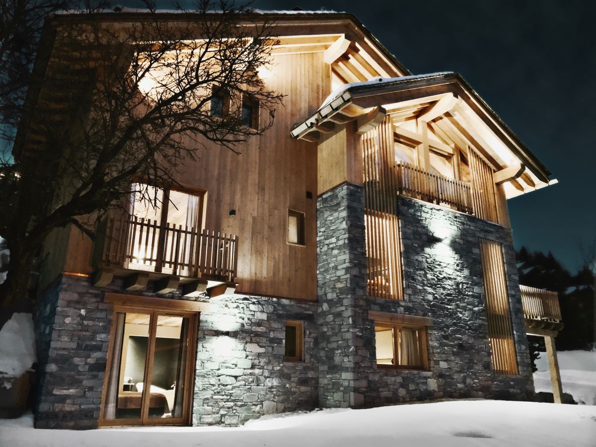 Chalet Caro, Meribel - chalet exterior lit up at night