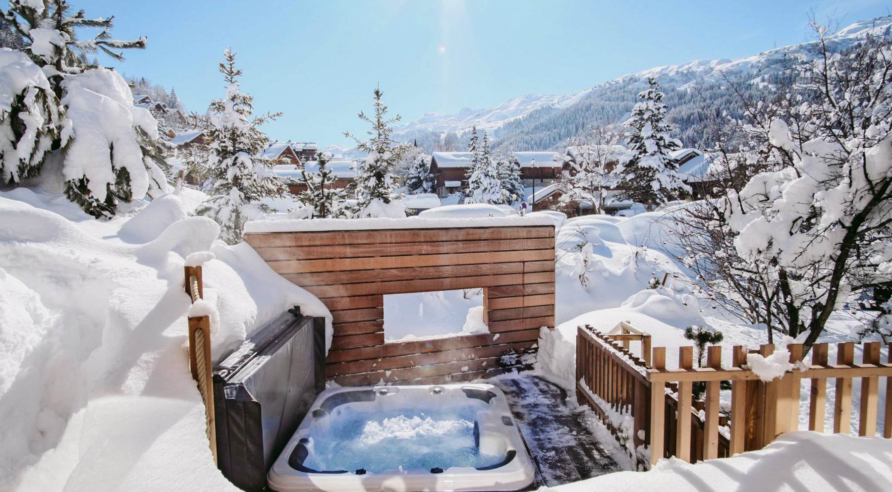 Chalet Caro, Meribel - outdoor hot tub with snow-covered trees in the background