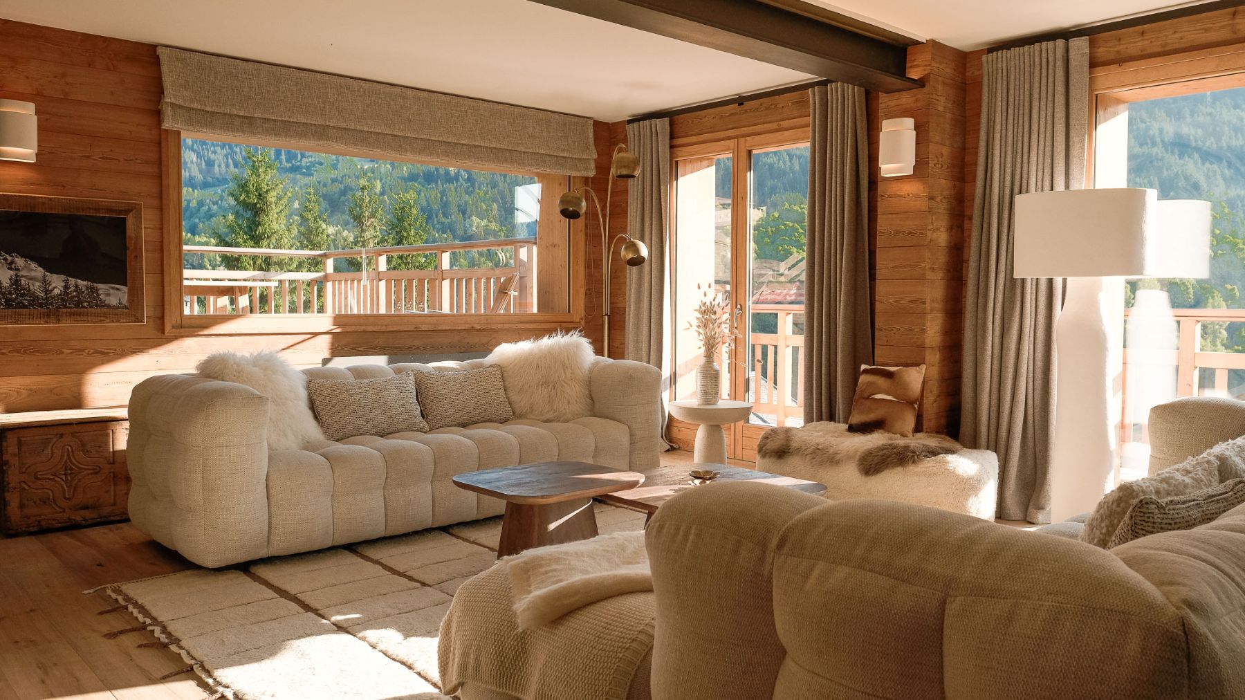 Chalet Etoile des Neiges, Meribel - living room with floor to ceiling windows and comfortable sofas