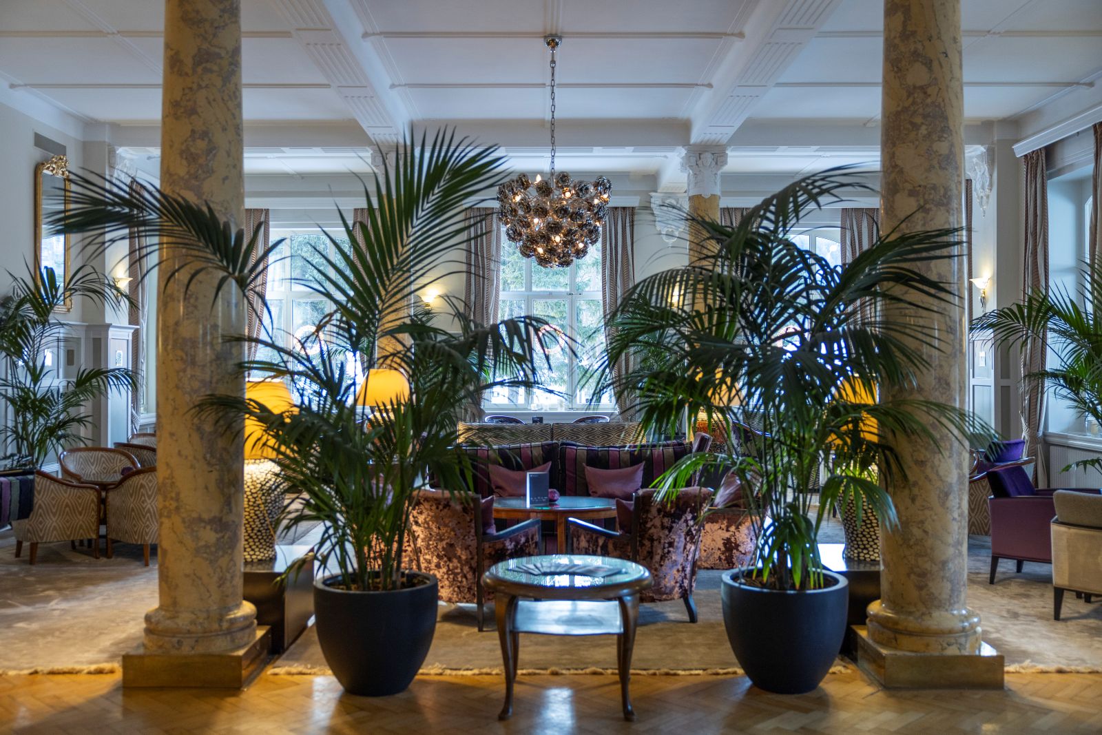 Hotel Cresta Palace, St Moritz - lounge bar with marble columns and large plants