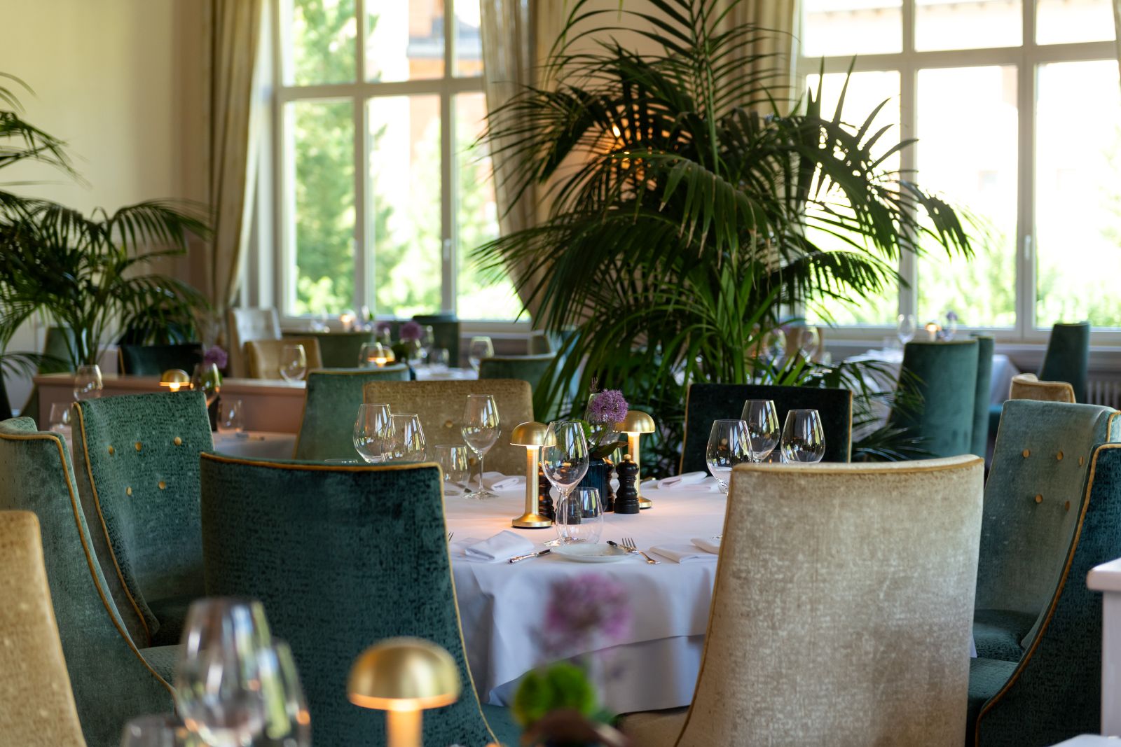Hotel Cresta Palace, St Moritz - grand restaurant with velvet seats and large plants