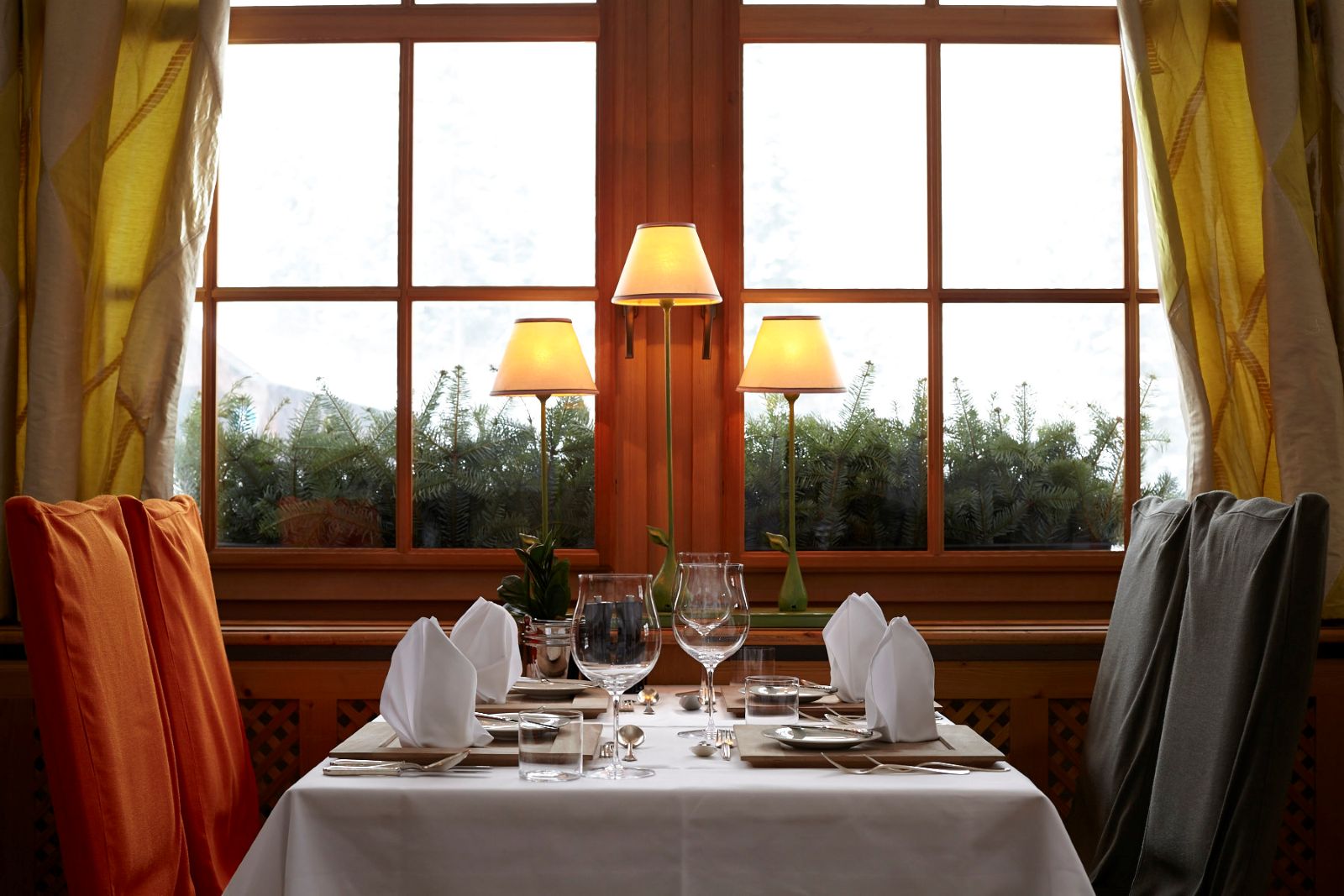 Raffl’s Tyrol Hotel, St Anton - traditional restaurant showing table next to the wooden window frame