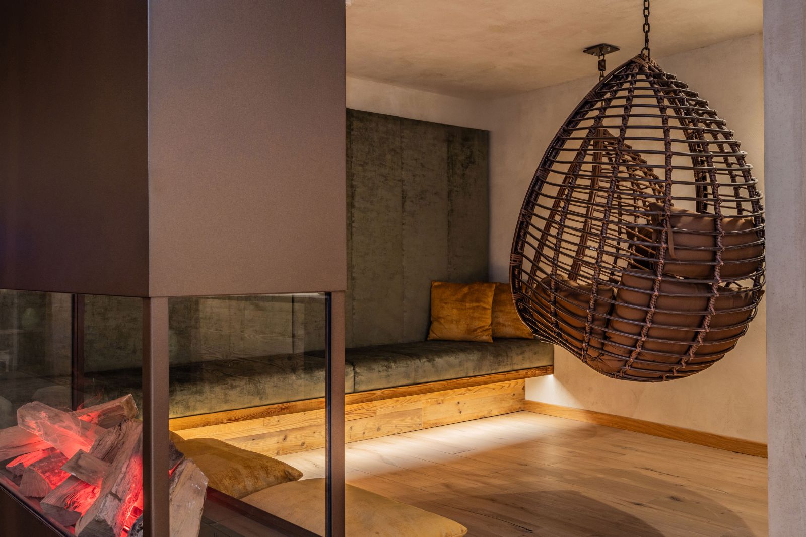 Sporthotel Romantic Plaza, Madonna di Campiglio - spa area with seats hanging from the ceiling and fireplace