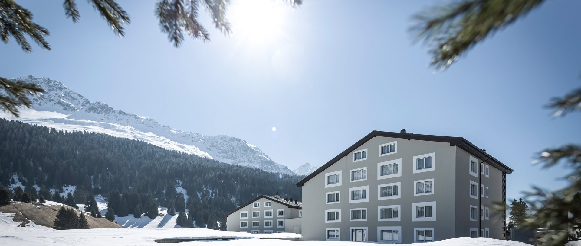 Valbella Resort Lenzerheide - resort exterior with snow-covered mountains behind