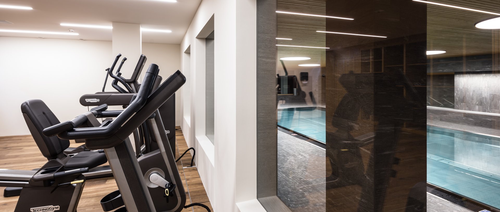 Valbella Resort Lenzerheide - fitness room overlooking indoor swimming pool